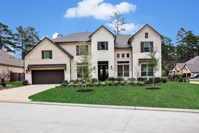 french country style house with a garage and a front lawn