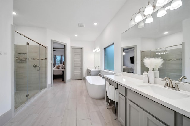 bathroom featuring vanity, separate shower and tub, and a chandelier