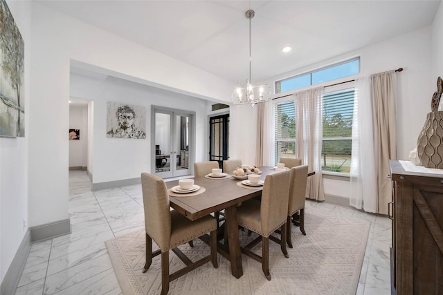 dining room with an inviting chandelier and french doors