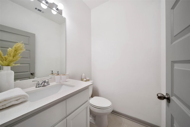 bathroom with vanity, toilet, and tile patterned flooring