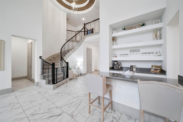 bar with built in shelves and a towering ceiling