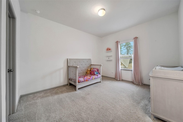 carpeted bedroom with a crib