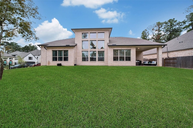 rear view of house featuring a lawn