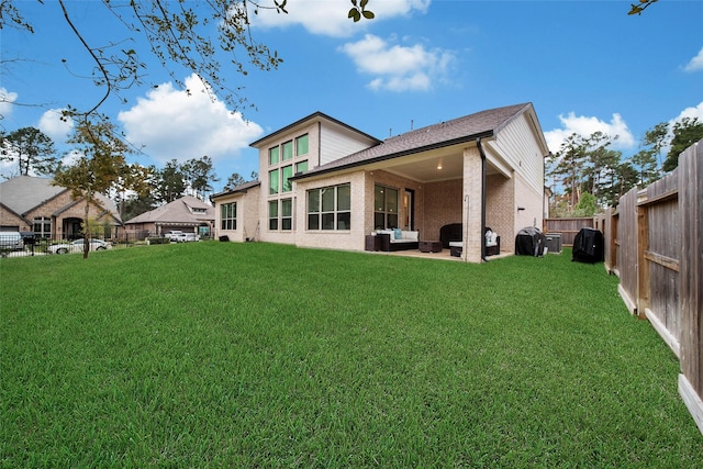 back of property featuring a yard and a patio area