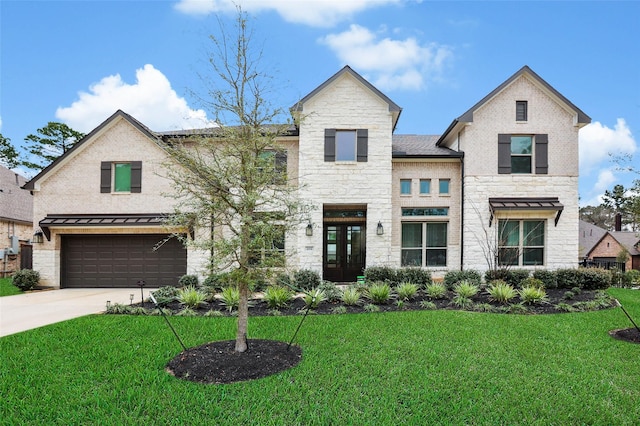 view of front of home featuring a garage and a front yard