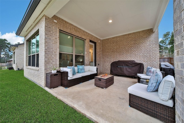 view of patio / terrace with area for grilling and an outdoor living space with a fire pit