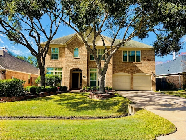 view of front of property with a garage and a front yard