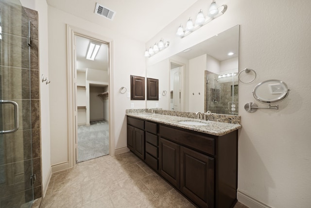 bathroom featuring vanity and an enclosed shower