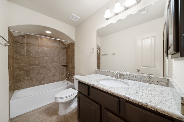 full bathroom with tiled shower / bath, vanity, toilet, and tile patterned floors