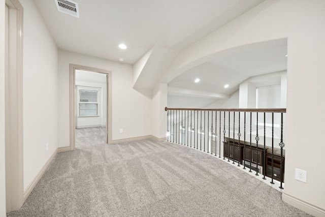 additional living space featuring light carpet and lofted ceiling