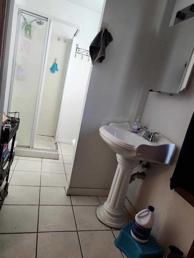 bathroom with walk in shower and tile patterned flooring