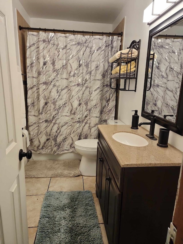 bathroom featuring vanity, walk in shower, tile patterned floors, and toilet