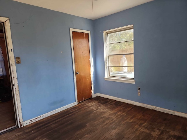 empty room featuring dark hardwood / wood-style flooring