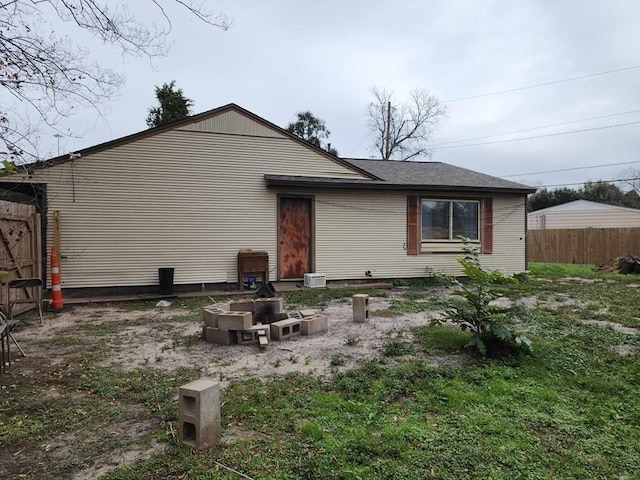 back of property featuring an outdoor fire pit