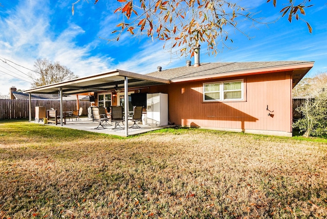 back of property featuring a yard, fence, and a patio