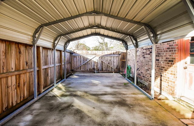 view of parking with a gate, fence, and a carport