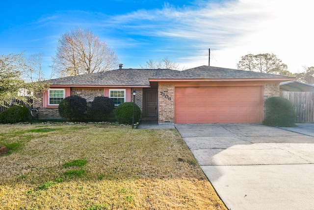 ranch-style house featuring an attached garage, brick siding, concrete driveway, and a front yard