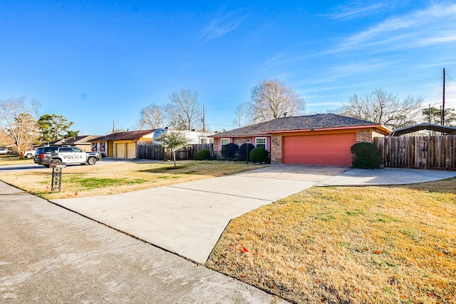 ranch-style house with a garage and a front lawn