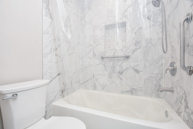 bathroom featuring shower / bathing tub combination and toilet