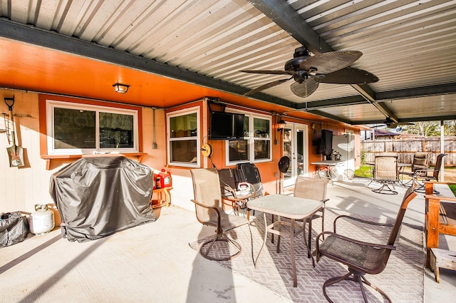 view of patio featuring fence, grilling area, a ceiling fan, and outdoor dining space