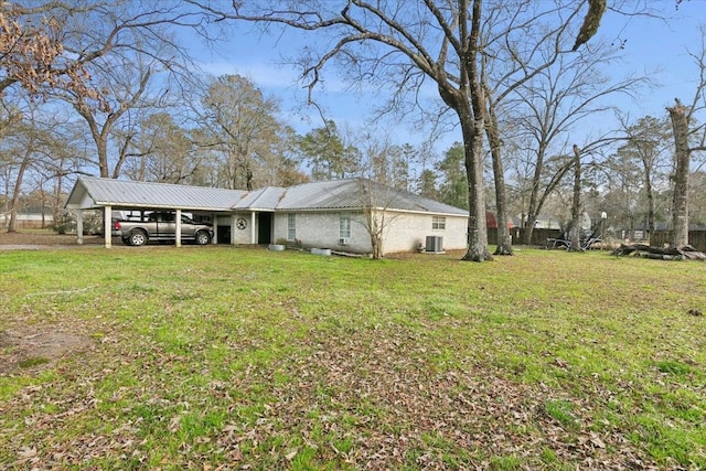 exterior space with a yard, central AC, and a carport