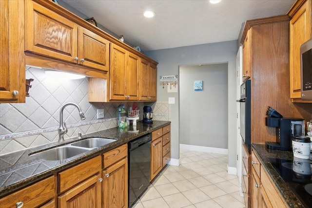 kitchen with sink, black appliances, light tile patterned floors, dark stone countertops, and backsplash