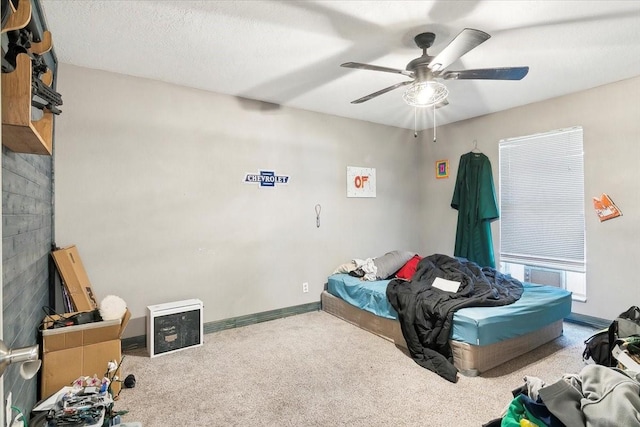 carpeted bedroom with a textured ceiling, a fireplace, and ceiling fan