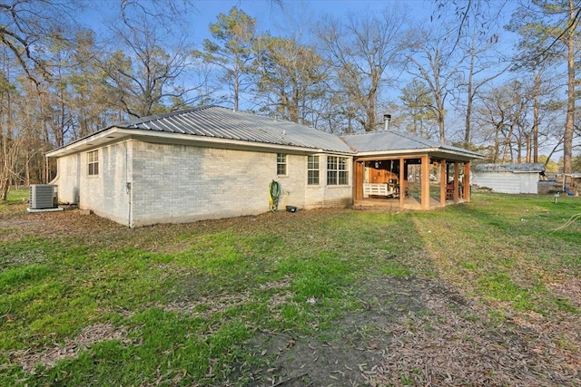 back of property featuring a yard and cooling unit