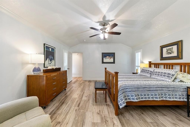 bedroom with crown molding, ceiling fan, vaulted ceiling, and light wood-type flooring