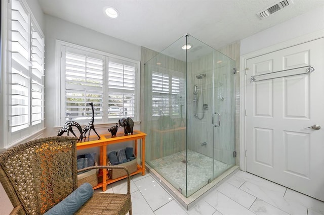 bathroom featuring a shower with shower door