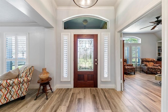 foyer featuring crown molding, ceiling fan, and light hardwood / wood-style floors