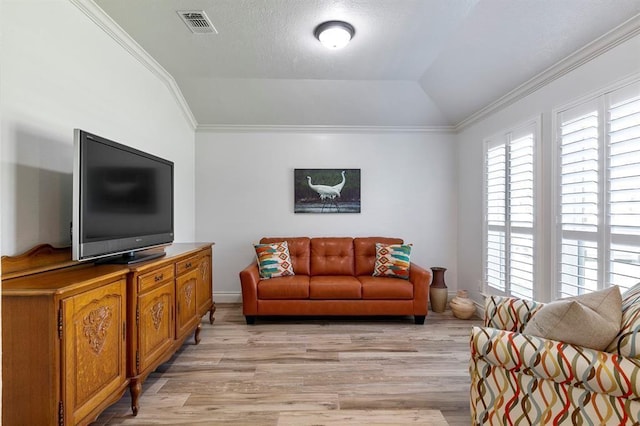 living room featuring lofted ceiling, light hardwood / wood-style flooring, ornamental molding, and a textured ceiling