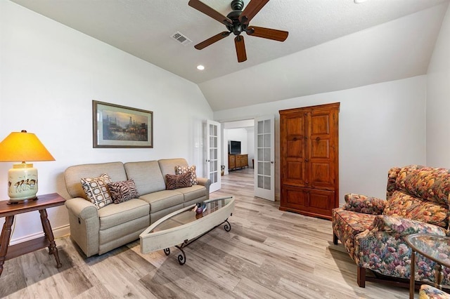 living room featuring french doors, ceiling fan, lofted ceiling, and light hardwood / wood-style floors