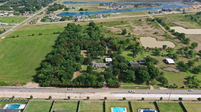 birds eye view of property with a water view and a rural view