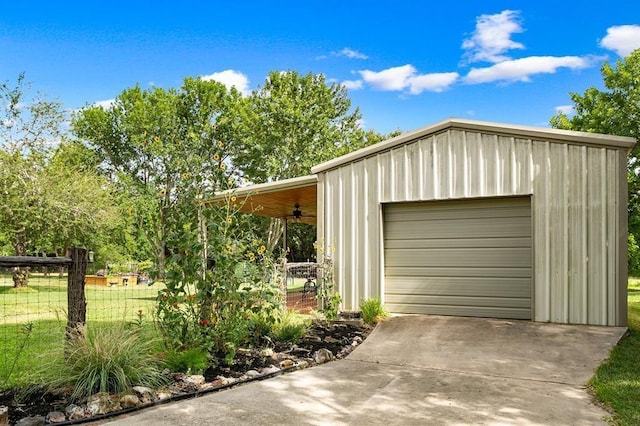 garage with a lawn and ceiling fan