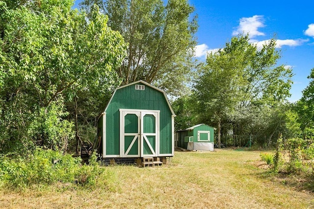 view of outdoor structure featuring a lawn