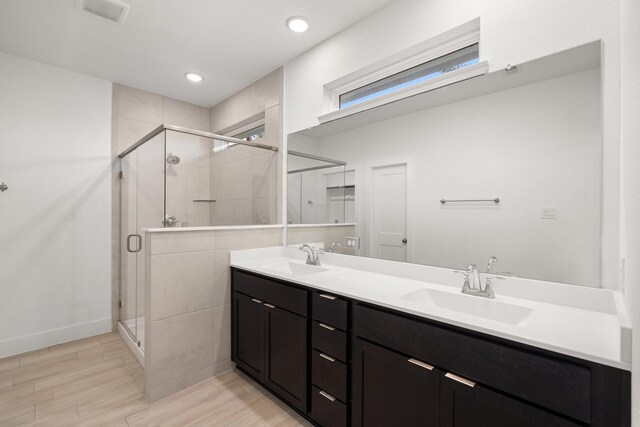 bathroom with vanity, hardwood / wood-style floors, and walk in shower