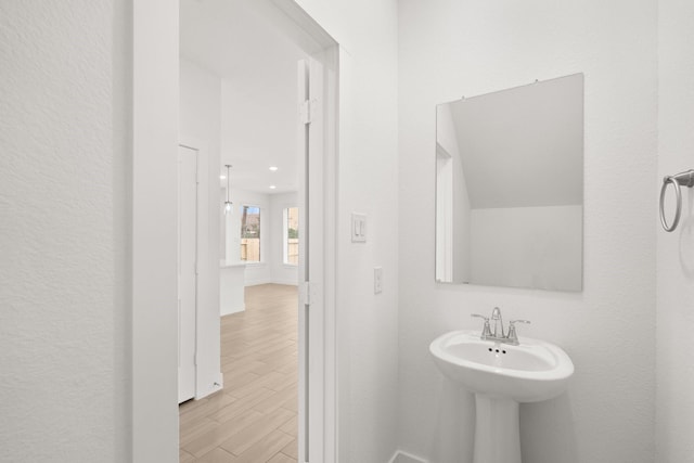 bathroom with hardwood / wood-style flooring and sink