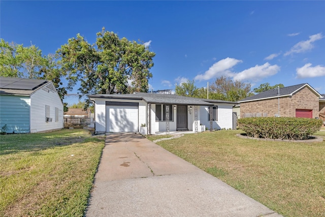 single story home featuring a garage and a front yard