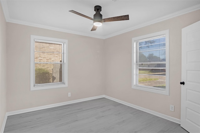 empty room with ornamental molding, ceiling fan, and light wood-type flooring