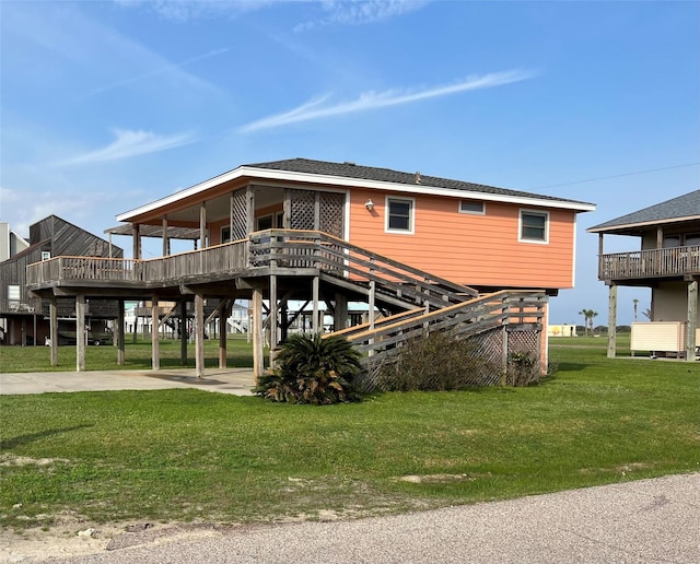 rear view of property featuring a yard and a carport