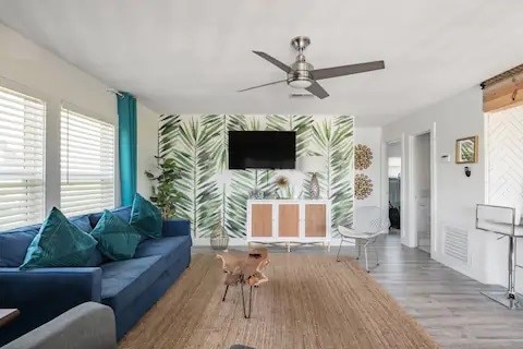 living room with ceiling fan and light hardwood / wood-style flooring