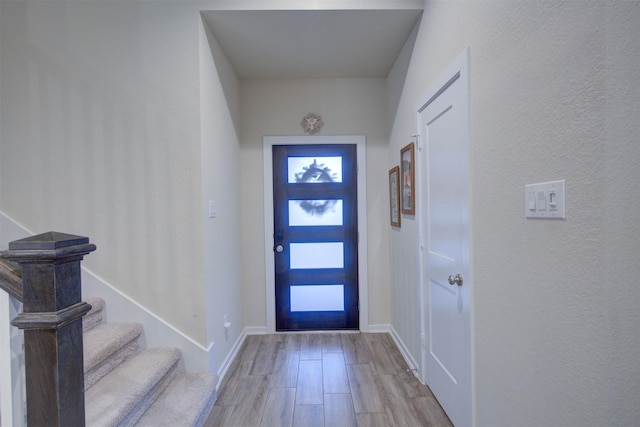 foyer entrance with light wood-type flooring