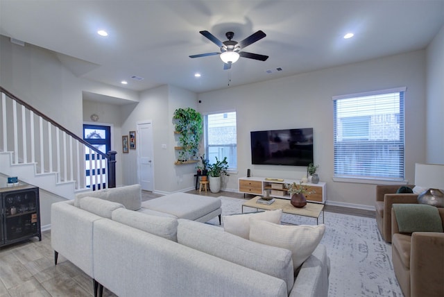 living room with ceiling fan and light hardwood / wood-style floors