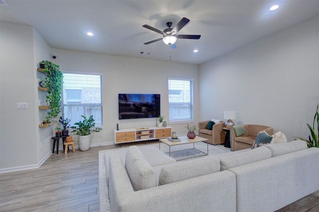 living room with ceiling fan and light hardwood / wood-style flooring