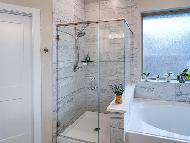 bathroom featuring independent shower and bath