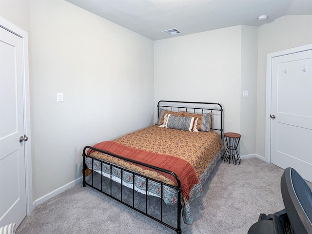 carpeted bedroom with lofted ceiling