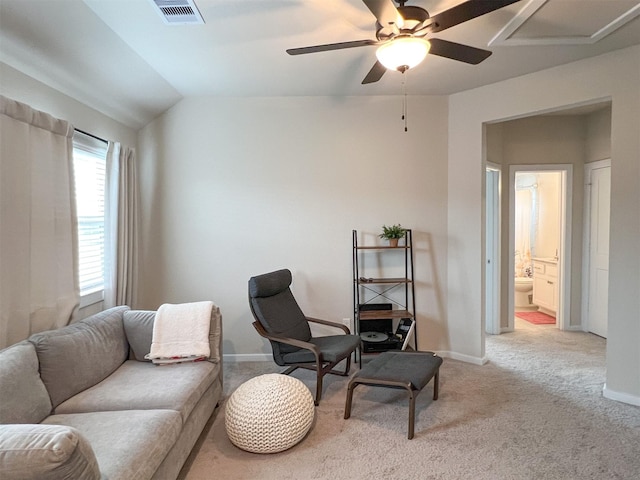 living area featuring vaulted ceiling, light carpet, and ceiling fan