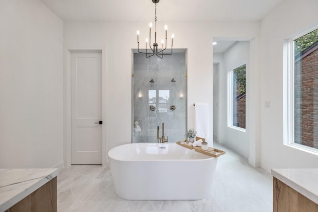 bathroom featuring vanity, shower with separate bathtub, and a notable chandelier