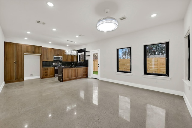 kitchen featuring stainless steel appliances and decorative light fixtures